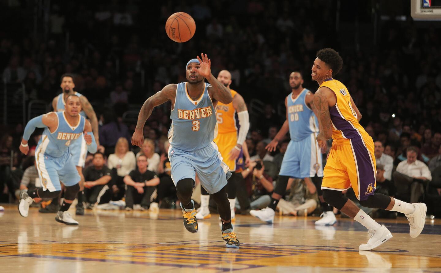 Denver guard Ty Lawson steals the ball from Nick Young late in the fourth quarter of the Lakers' 106-96 loss to the Nuggets at Staples Center.