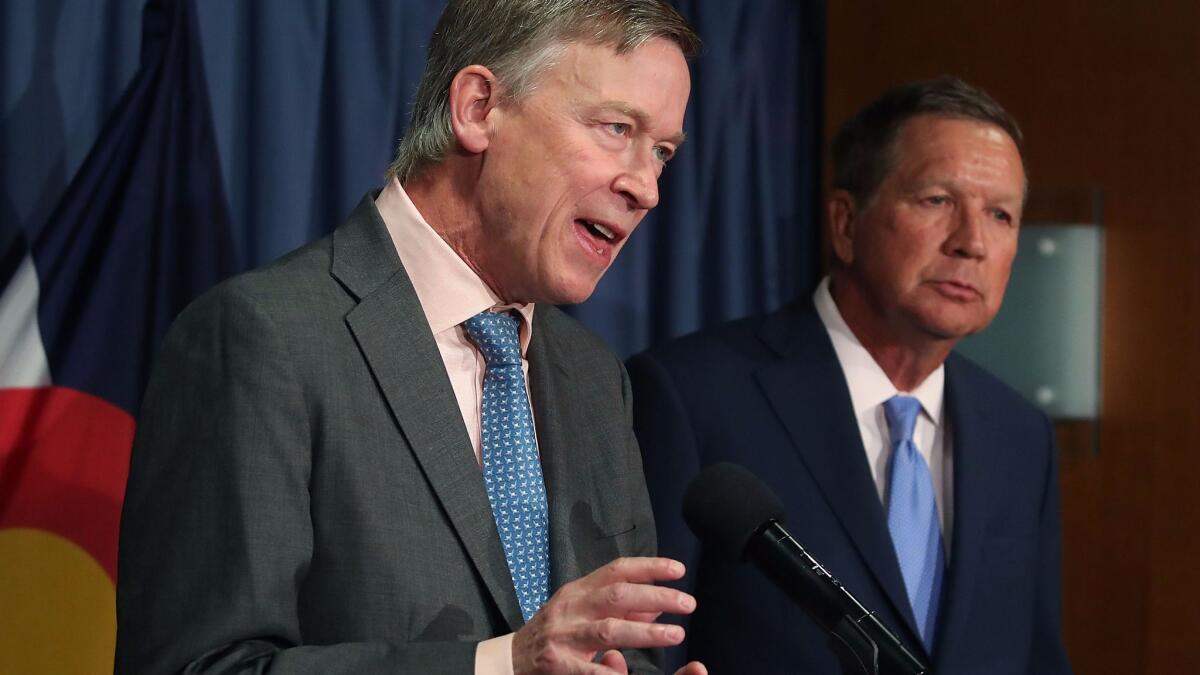 Gov. John Hickenlooper (D-Colo.), left, and Gov. John Kasich (R-Ohio) participate in a bipartisan news conference to discuss the Senate healthcare bill in Washington.