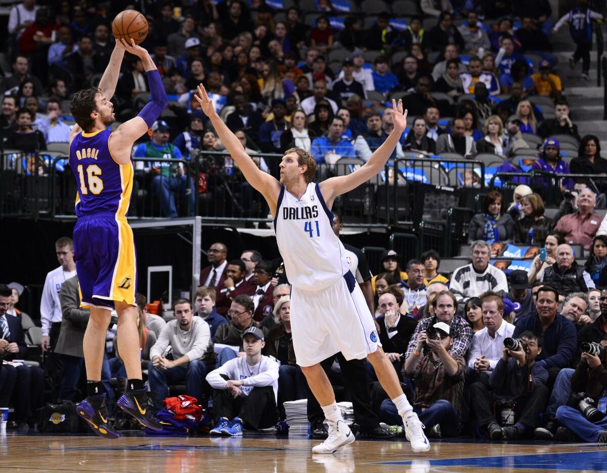 Lakers center Pau Gasol shoots over Dallas Mavericks forward Dirk Nowitzki.