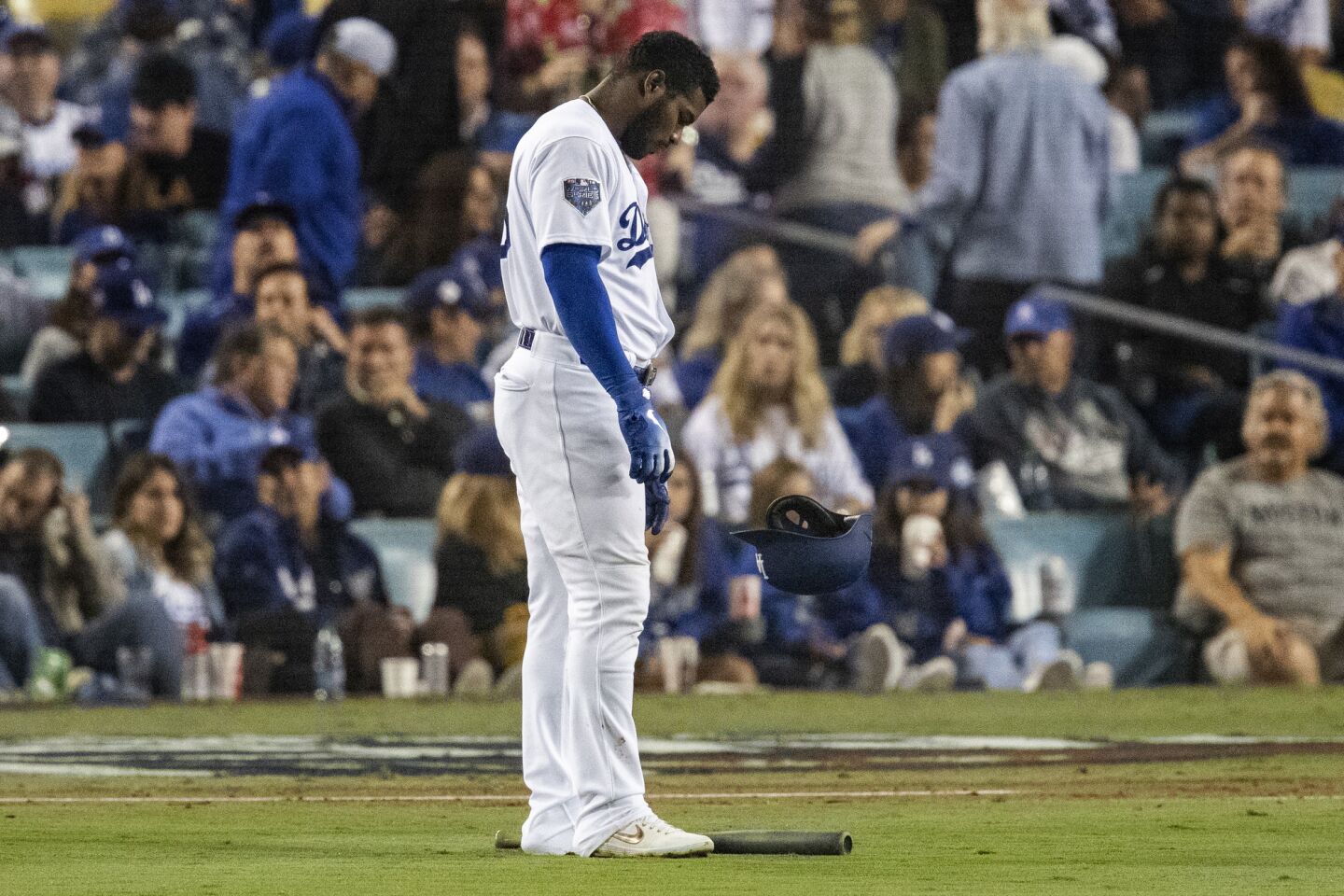 Dodgers right fielder Yasiel Puig drops his bat and helmet in the infield after flying out to end the fourth inning.
