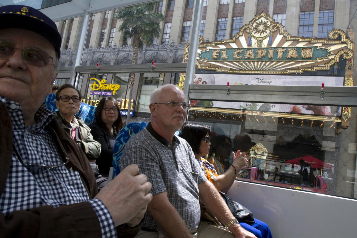 Movie fans ride a tour bus around Hollywood and Los Angeles on March 28, 2014. Turner Classic Movies (TCM) teamed up with Starline Tours to offer more than 20 excursions to current film locations, studios and historical film landmarks as part of TCM's 20th anniversary celebrations April 10-13.