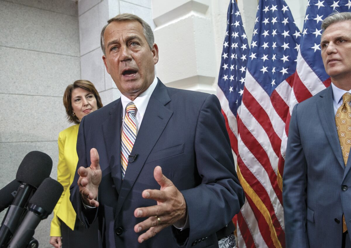 House Speaker John A. Boehner, flanked by Rep. Cathy McMorris Rodgers and Majority Leader Kevin McCarthy, speaks to reporters on Capitol Hill on Tuesday.