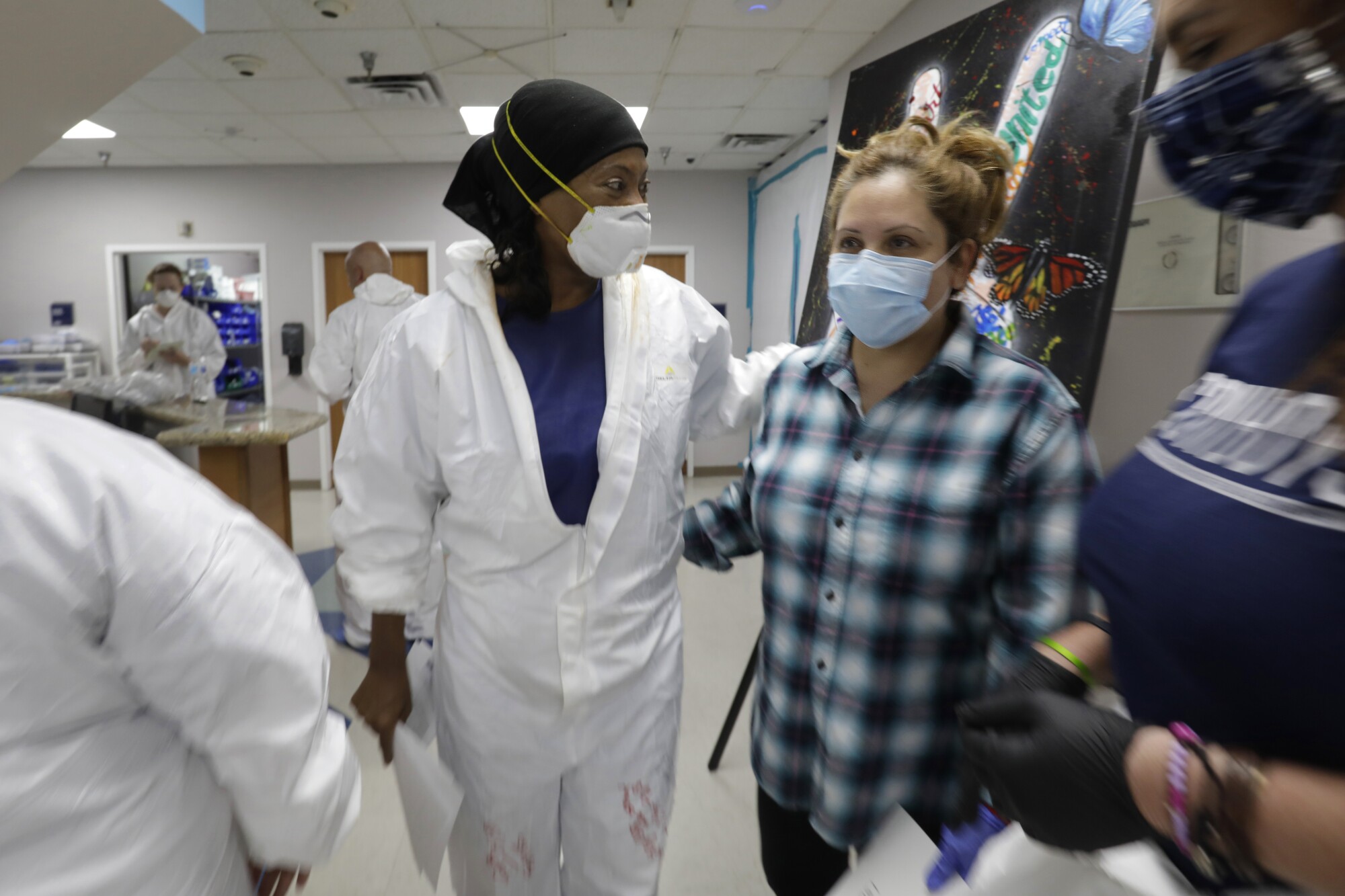 Nurse Sherron Lovelady, left, helps discharge COVID patient Ruth Medrano, 46, from United Memorial Medical Center in Houston.