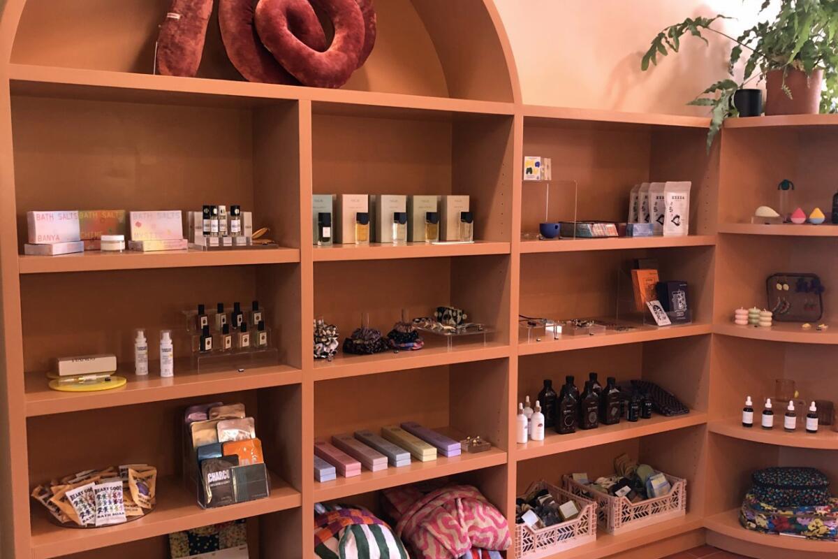 Shelves are lined with perfume, oils, candles and other gifts. 