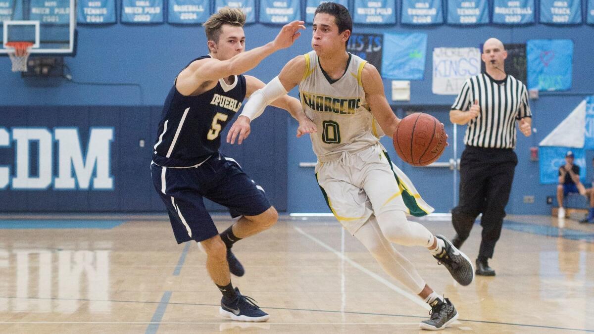 Edison's David Atencio dribbles past Dos Pueblos' defense and scores two of his game-high 21 points on Monday.