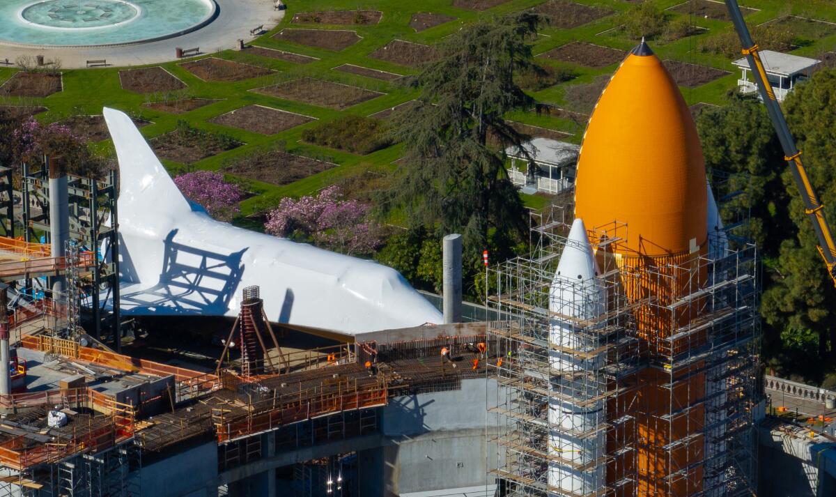 The space shuttle Endeavour sits near its external fuel tanks.