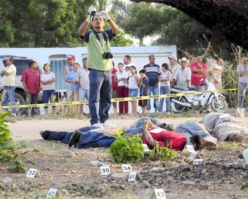 Mexican Police experts check the crime scene where five dead people were found in Novolato, Sinaloa State, Mexico.