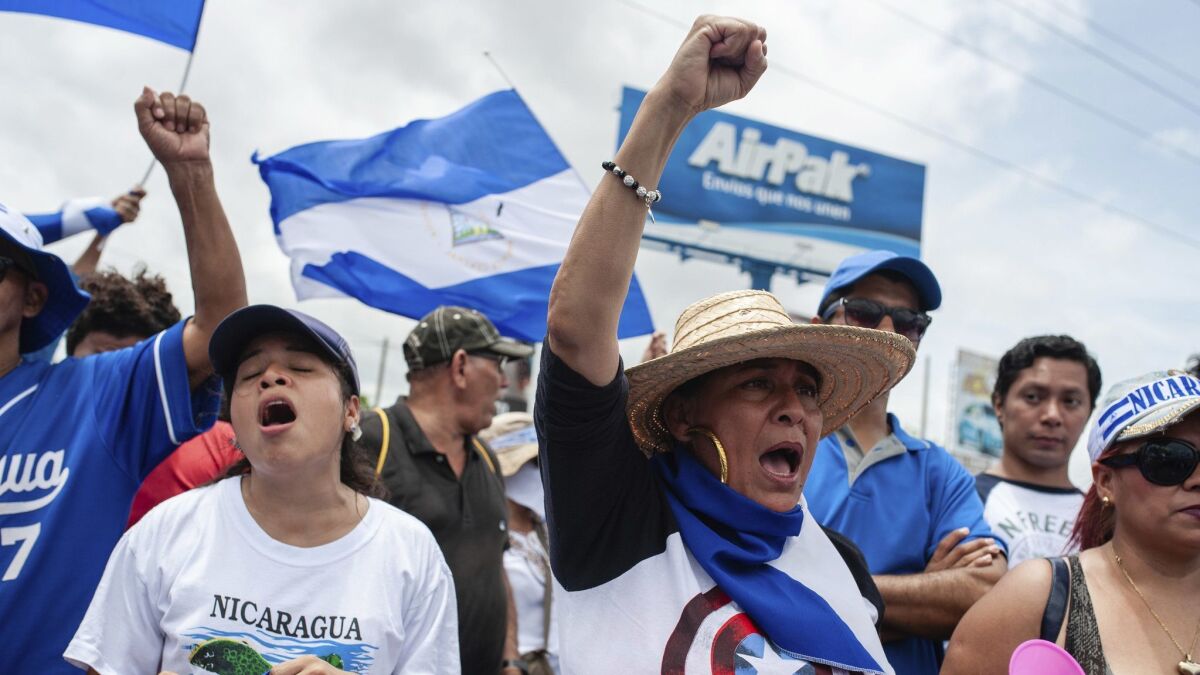 Anti-government demonstrators on Saturday take part in a march demanding the ouster of President Daniel Ortega and the release of political prisoners, in Managua, Nicaragua.