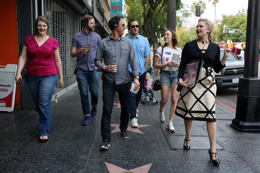 LOS ANGELES, CA-MARCH 19, 2019: April Clemmer, right, leads a walking tour in Hollywood to a group of co-workers from Ecclesia on March 19, 2019, in Los Angeles, California. Clemmer has banded together with several other tour guides to start a Los Angeles Tour Guide Assn. to create a certification process for tour guides. (Photo By Dania Maxwell / Los Angeles Times)