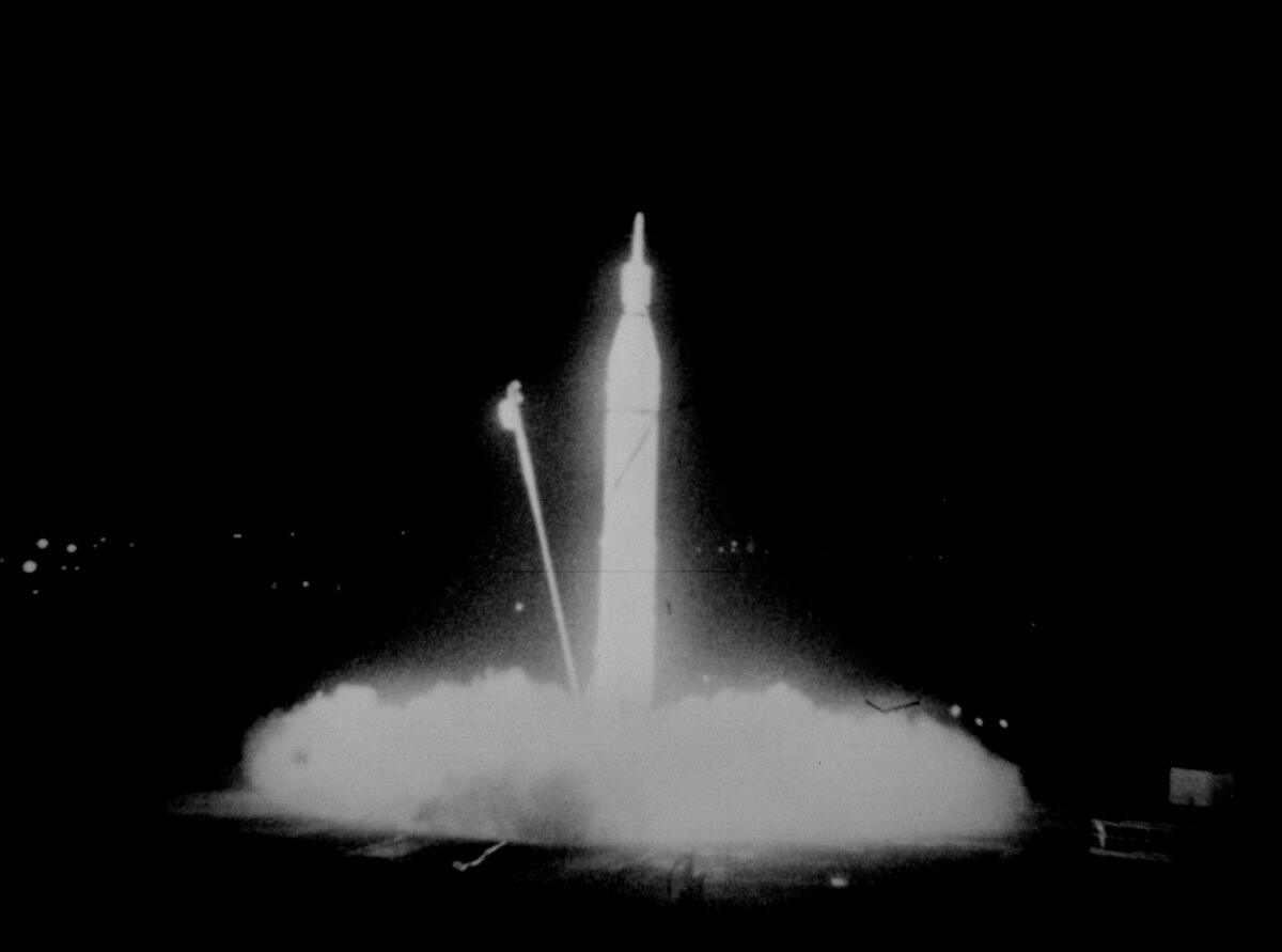 The Jupiter-C rocket carrying the satellite Explorer 1 takes off in Cape Canaveral. A service line can be seen falling away from its nose.