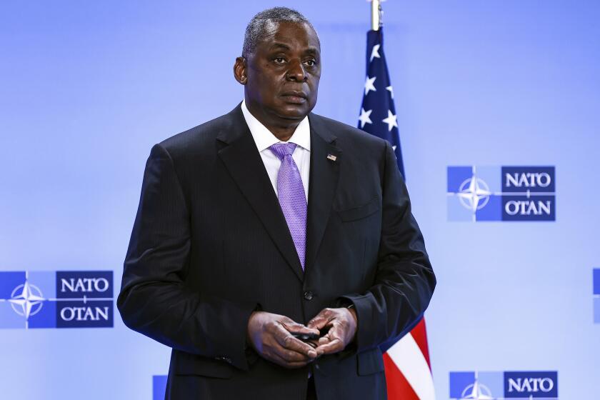FILE - In this April 14, 2021, file photo, Secretary of Defense Lloyd Austin poses for photographers as he arrives at NATO headquarters in Brussels. The Associated Press has learned that a Pentagon panel is recommending that decisions to prosecute service members for sexual assault be made by independent authorities, not commanders. It would be a major reversal of military practice and a change long sought by Congress members. (Kenzo Tribouillard, Pool via AP)