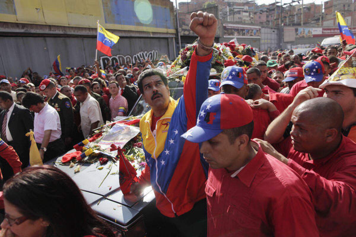 Venezuelan Vice President Nicolas Maduro looks to the heavens as he escorts the coffin carrying the body of late President Hugo Chavez through the streets of Caracas on Wednesday. Maduro is likely to benefit from Chavez's enduring influence on Venezuelan politics, as the late president made a deathbed endorsement of Maduro as best to succeed him.