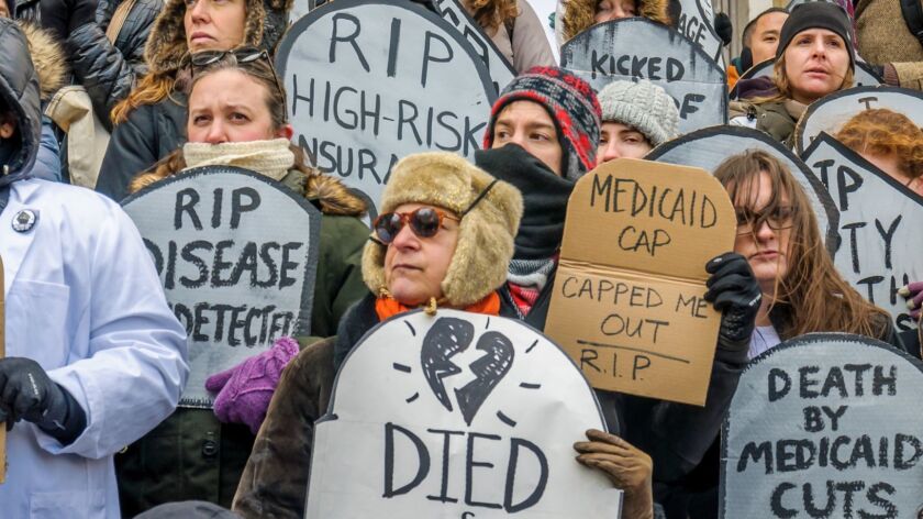 People hold a rally in support of Obamacare on March 11, 2017, in New York City.