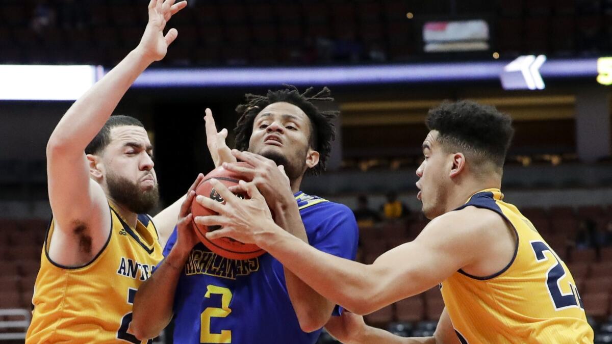 UC Irvine guard Darrian Traylor, right, fouls UC Riverside guard Jordan Gilliam, middle, as Spencer Rivers helps defend during second half of a Big West men's tournament game in Anaheim on March 14.