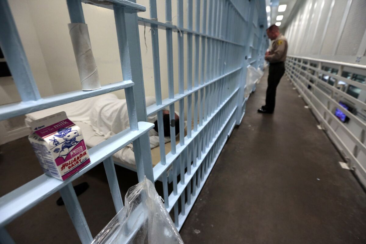 A sheriff's deputy checks on an inmate in a renovated section of Men's Central Jail.