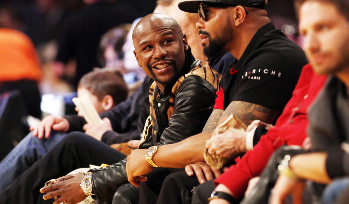 Boxer Floyd Mayweather Jr. sits on the sideline during an NBA basketball game between the Los Angeles Lakers and the Golden State Warriors at the Staples Center on March 6.