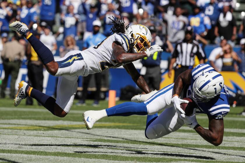 Robert Gauthier  Los Angeles Times THE CHARGERS’ Rayshawn Jenkins tries to break up a pass to the Colts’ Eric Ebron in the end zone.