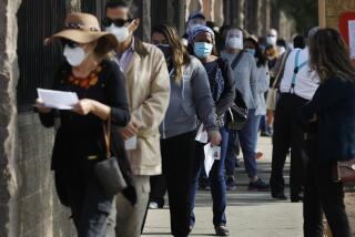 LOS ANGELES-CA-JANUARY 5, 2021: People line up at a checkpoint to be vaccinated at W. 79th Street and S. Mariposa Avenue in South Los Angeles on Tuesday, January 5, 2021. Los Angeles Fire Department officials turned people away who are not health care workers with the proper documentation and appointment. (Christina House / Los Angeles Times)