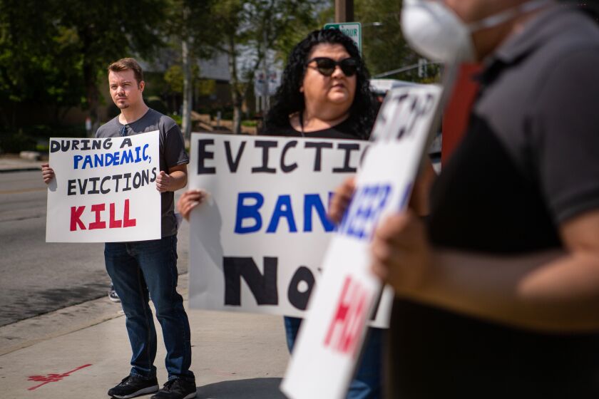 EL MONTE, CA - MARCH 29: Ian Jameson (left) of El Monte organized a gathering of tenant rights activists at the El Monte City Hall to demand that the El Monte City Council pass an eviction moratorium barring all evictions during the coronavirus pandemic on Sunday, March 29, 2020 in El Monte, CA. (Jason Armond / Los Angeles Times)