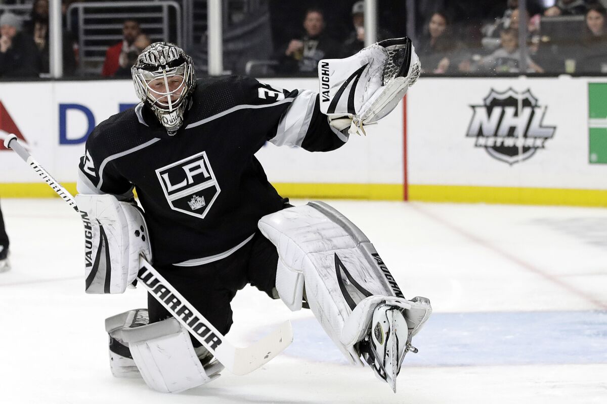 FILE - Los Angeles Kings goaltender Jonathan Quick stops a shot during the third period of an NHL hockey game against the Colorado Avalanche in Los Angeles, in this Monday, March 9, 2020, file photo. Quick is used to being in net for more than 75% of the Kings' games, but that might change this season with trying to play 56 games in a condensed time frame. (AP Photo/Marcio Jose Sanchez, File)