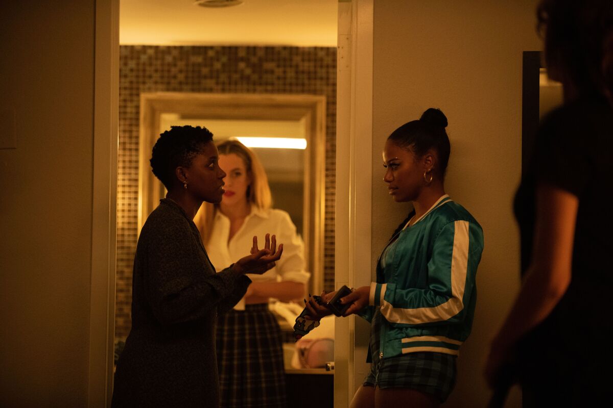 Filmmaker Janicza Bravo, left, gives direction to actresses Riley Keough and Taylour Paige on the set of "Zola."