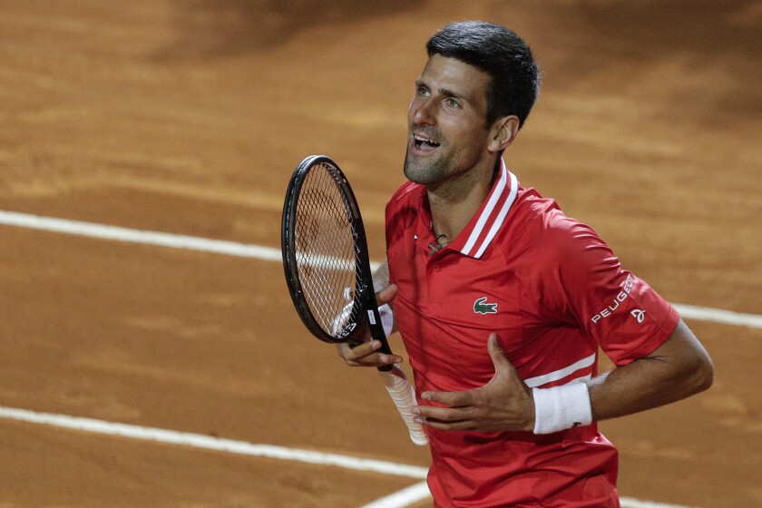 Serbia's Novak Djokovic celebrates after beating Italy's Lorenzo Sonego in their semi-final match at the Italian Open tennis tournament, in Rome, Saturday, May 15, 2021. Djokovic won 6-3 6-7 6-2 and will play Rafael Nadal in the final. (AP Photo/Gregorio Borgia)