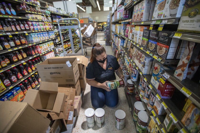 Wearing a face mask Kristina Brown, 35, is working at Fresco Community Market.