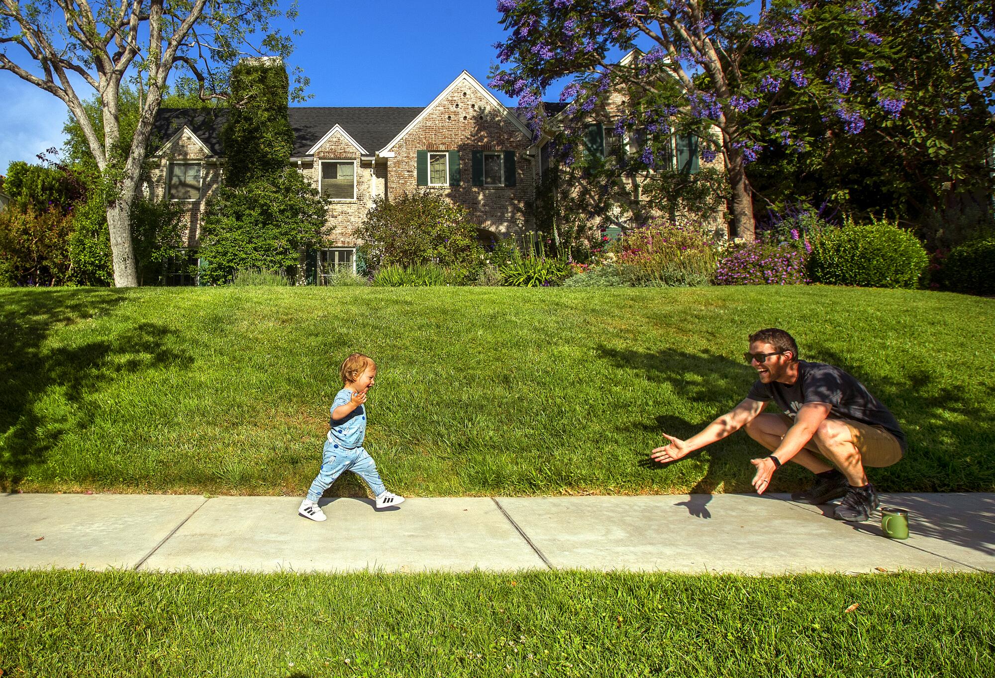 Leo Granas, 1, runs toward his father, Ben Granas. 