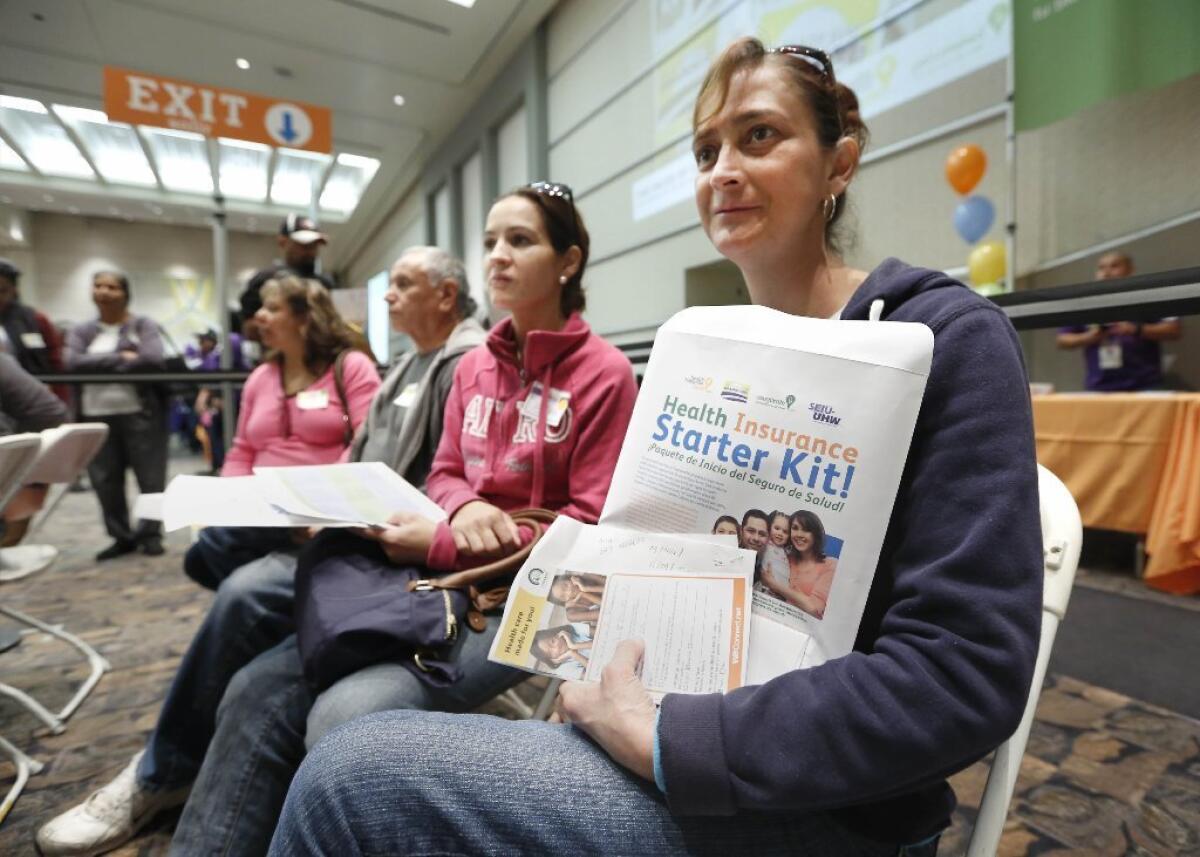 Californians wait to sign up for health insurance at a recent enrollment fair in Sacramento as part of the federal healthcare law.