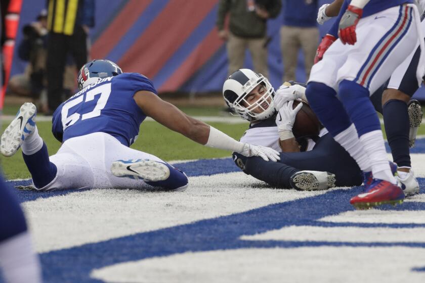 Rams tight end Tyler Higbee catches a pass for a touchdown in font of New York Giants Keenan Robinson.