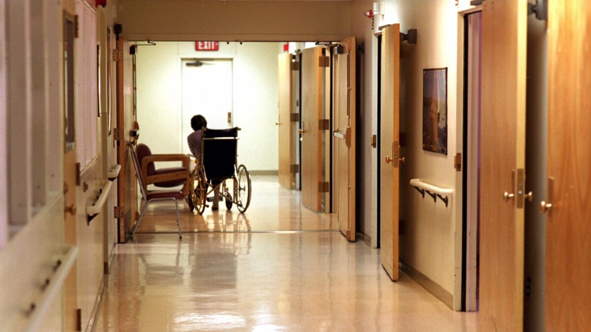 A patient makes his way down the hall of a ward for the mentally ill at Camarillo State Hospital.