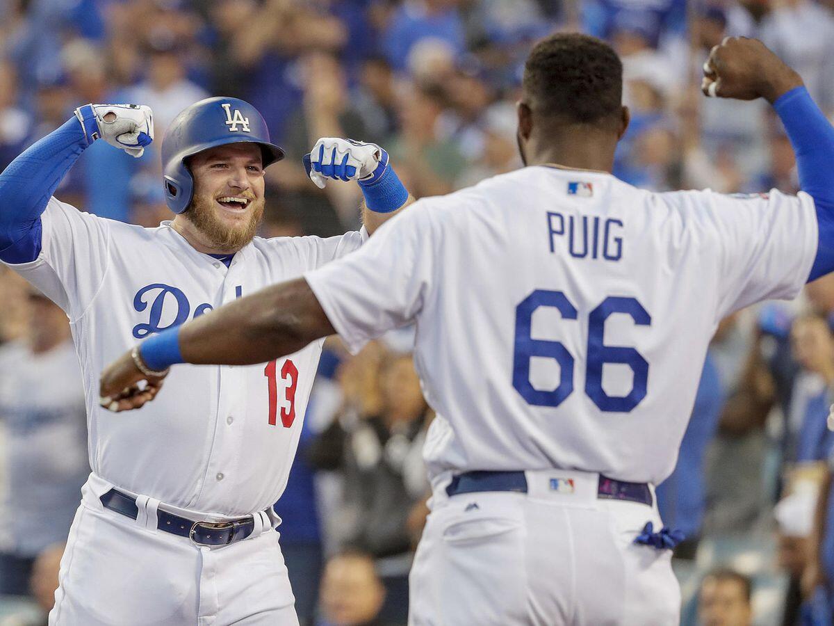 Max Muncy celebrates with Yasiel Puig after hitting a home run in the second inning.