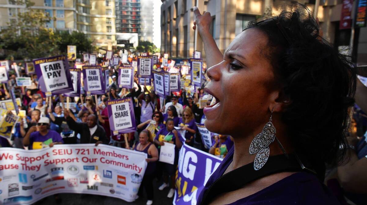 Thousands of Service Employees International Union members rally during a march at the California Plaza in downtown Los Angeles on their way to the Kenneth Hahn Hall of Administration. They were demanding a better contract offer from L.A. County.