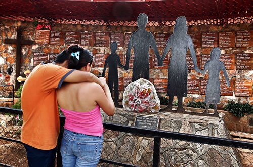 Cristian Figueroa, 23, and his wife, Mariana Cunadas Figueroa, 26, embrace at the memorial in El Mozote, El Salvador, to the victims of the 1981 attack by an army unit in which up to 900 people were raped, tortured and massacred.