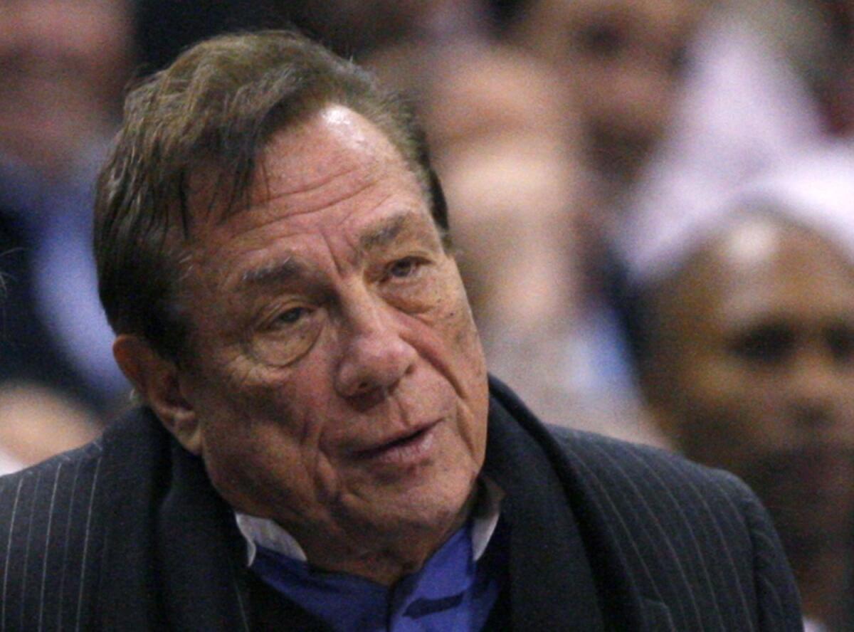 Los Angeles Clippers owner Donald Sterling sits on the sidelines wathcing his team play the New York Knicks in their NBA basketball game in Los Angeles in this February 11, 2009 file photo.