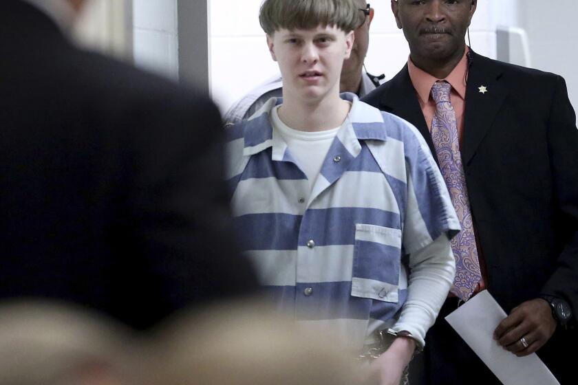 FILE - Dylann Roof enters the court room at the Charleston County Judicial Center to enter his guilty plea on murder charges on April 10, 2017, in Charleston, S.C. Roof's death sentence and conviction in the 2015 racist slayings of nine members of a Black South Carolina congregation should be upheld and don't merit review by the U.S. Supreme Court, attorneys for the federal government wrote in an expected filing on Wednesday, Aug. 31, 2022. (Grace Beahm/The Post And Courier via AP, Pool, File)
