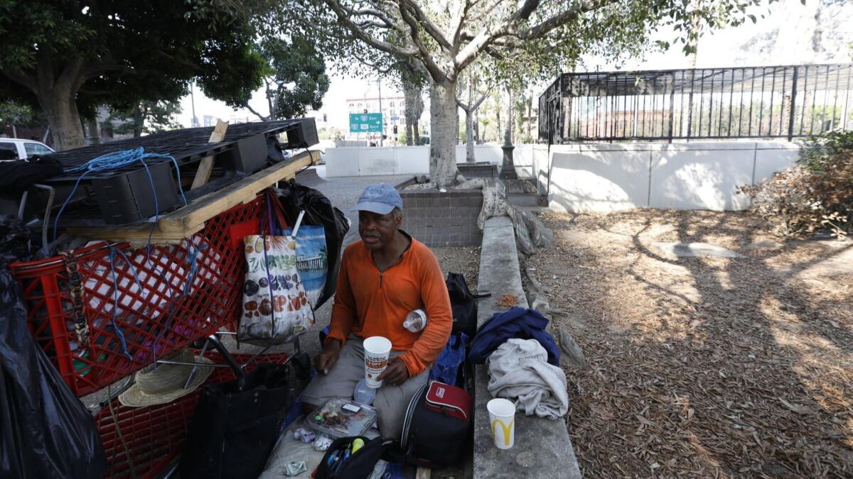 Alvaron Morrow, 57, rests outside the former Los Angeles Children's Museum downtown. The city is considering converting the site into crisis housing for homeless people.