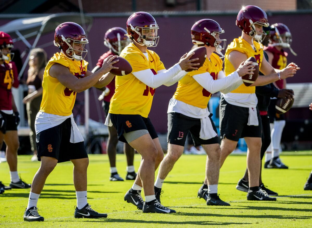 USC quarterbacks Brad Akoi, Caleb Williams, Isaac Ward and Miller Moss run through passing drills.