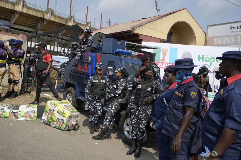 Nigeria police officers and Civil Defence provides security during an election campaign of Bola Ahmed Tinubu, presidential candidate of the All Progressives Congress, Nigeria's ruling party, ahead of 2023 Presidential elections in Lagos, Nigeria, Saturday, Nov. 26, 2022. A surge of violence targeting Nigeria's election commission offices and extremist attacks in remote communities are already raising concerns about the upcoming February elections in Africa's most populous nation. (AP Photo/Sunday Alamba)