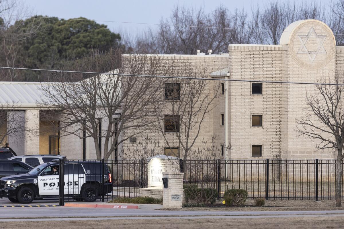 Police and their cars are in front of the Congregation Beth Israel synagogue on Sunday in Colleyville, Texas. 