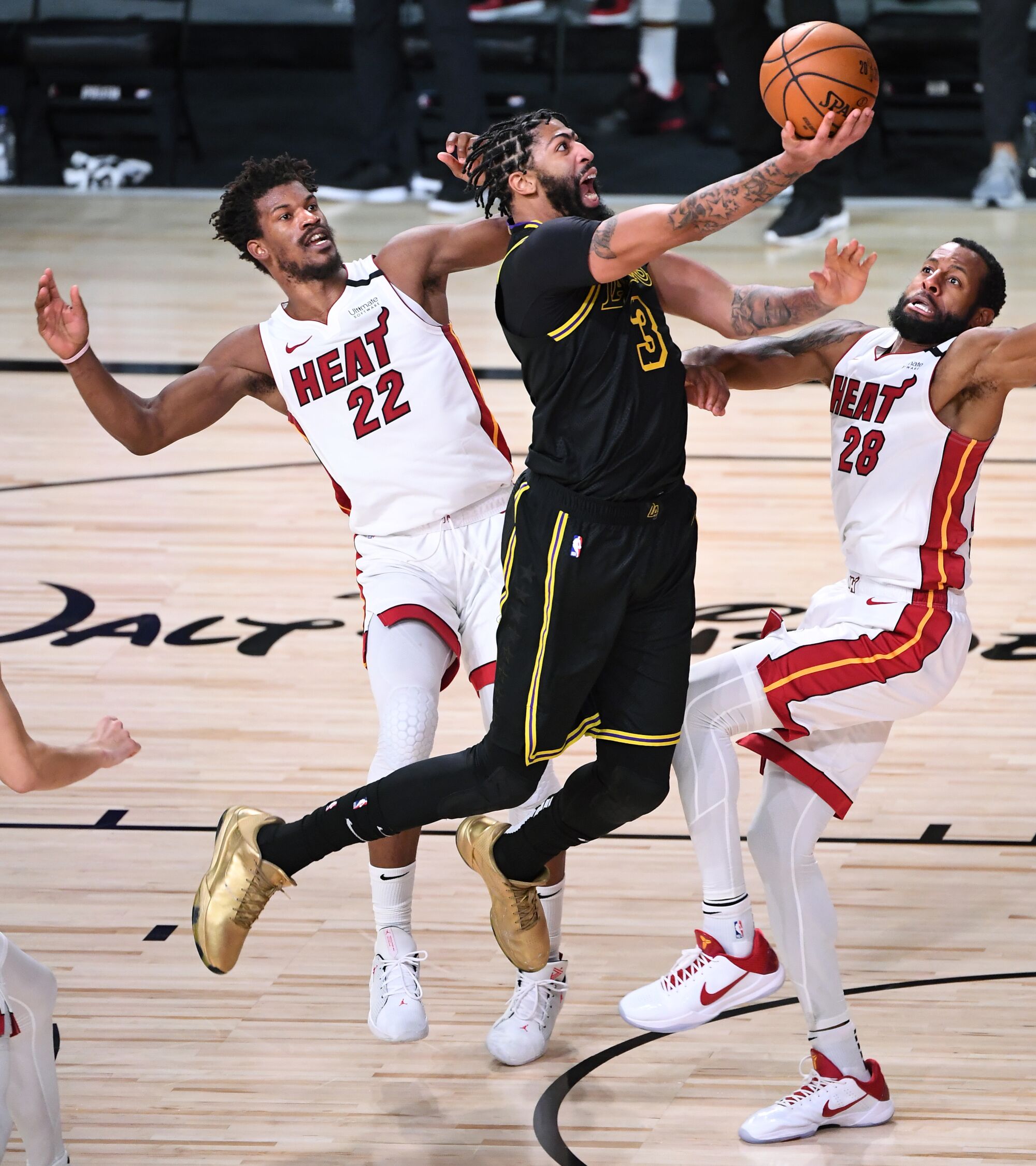 Lakers forward Anthony Davis is fouled by Miami Heat guard Andre Iguodala.