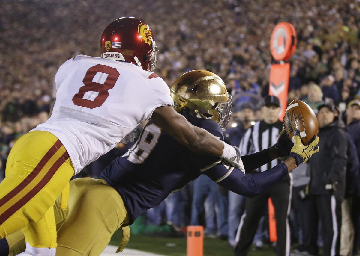 Notre Dame receiver Corey Robinson makes a 10-yard touchdown catch while being defended by USC corner Iman Marshall during fourth quarter.