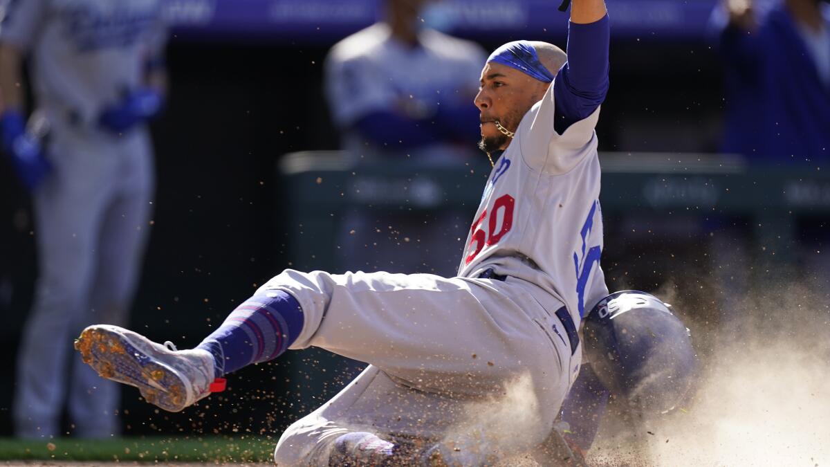Dodgers right fielder Mookie Betts slides into home during a game against the Colorado Rockies on April 1.