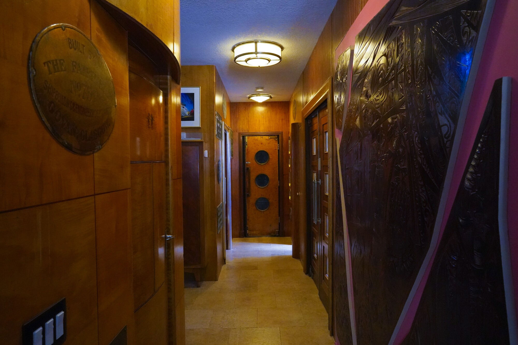 A hallway in Peter Knego's home features carved wood panels and a three-window door from the 1956 Empress of Britain.
