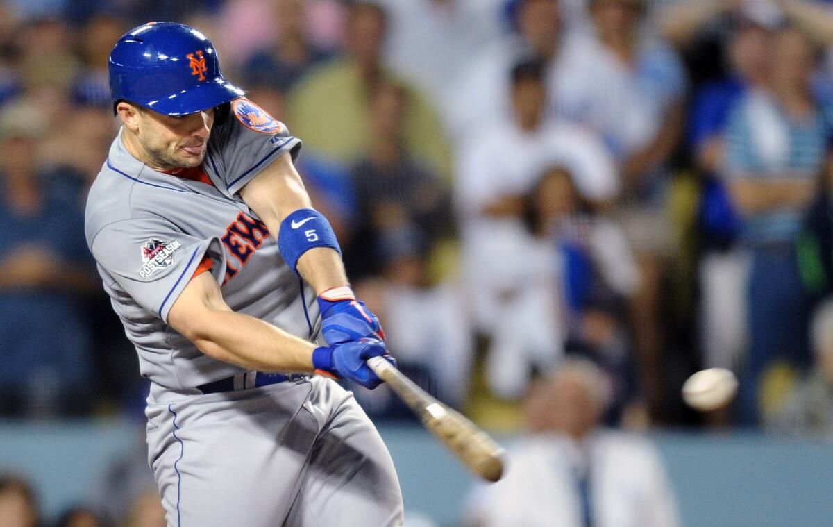 Mets third baseman David Wright hits a two-run single in the seventh inning against Dodgers pitcher Pedro Baez in Game 1 of the NLDS at Dodger Stadium.