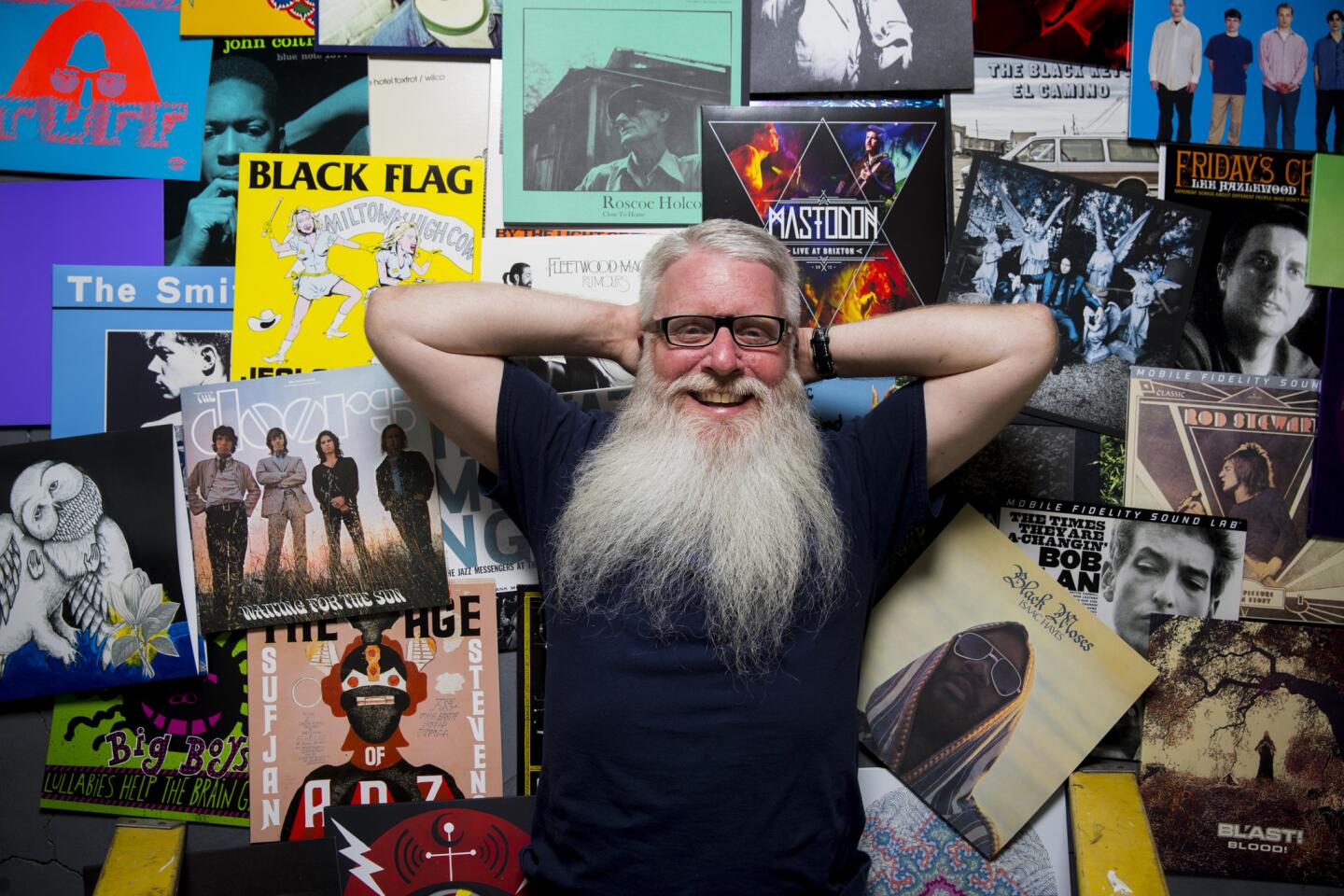 Rob Maushund, who's racked up 26 years with Stoughton Printing, works closely with music labels to deliver what they want. He lies atop a mini-history of his work.