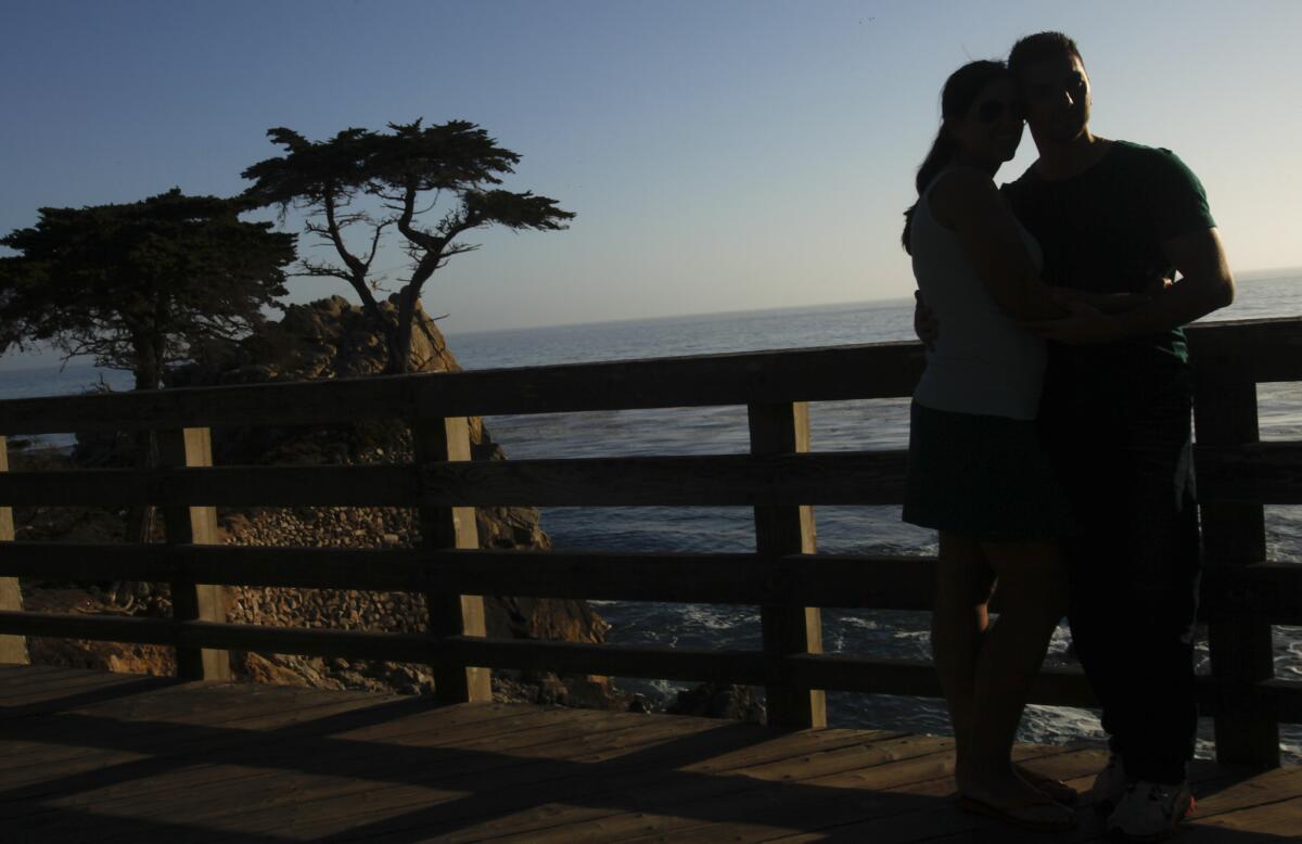 A couple stop for a photo of the Lone Cypress in Pebble Beach, Calif. Chef Roy Yamaguchi will be in Pebble Beach on Sept. 25 to host a luau at Roy's restaurant.