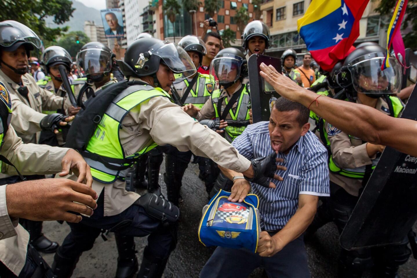 Demonstrators clash with police during a protest against Venezuelan President Nicolas Maduro's Government in Caracas, Venezuela.