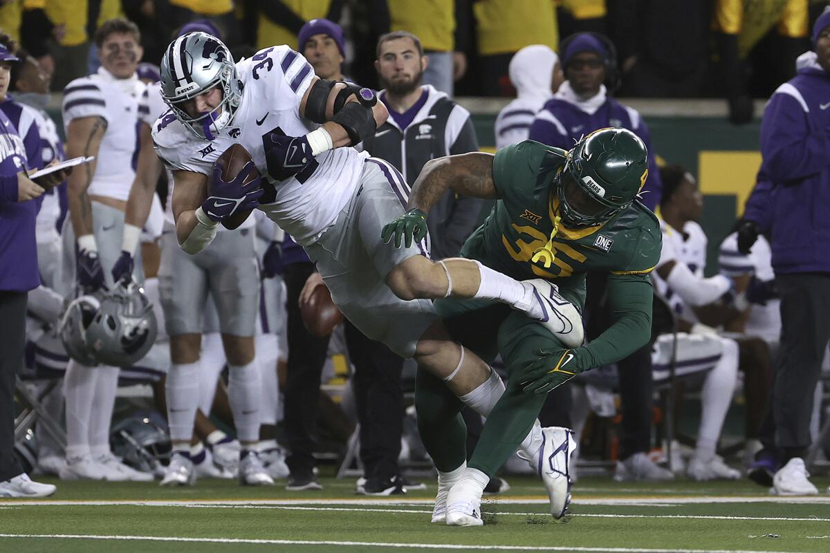 Kansas State tight end Ben Sinnott catches a pass over Baylor linebacker Jackie Marshall in the first half of an NCAA college football game, Saturday, Nov. 12, 2022, in Waco, Texas. (AP Photo/Jerry Larson)