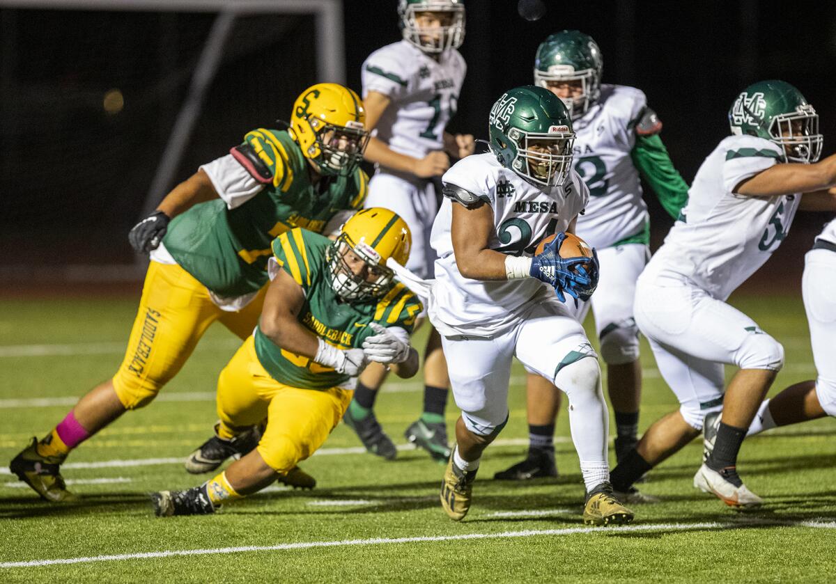 Costa Mesa's Kobe Lemari runs up field against Saddleback during an Orange Coast League game at Segerstrom High School.